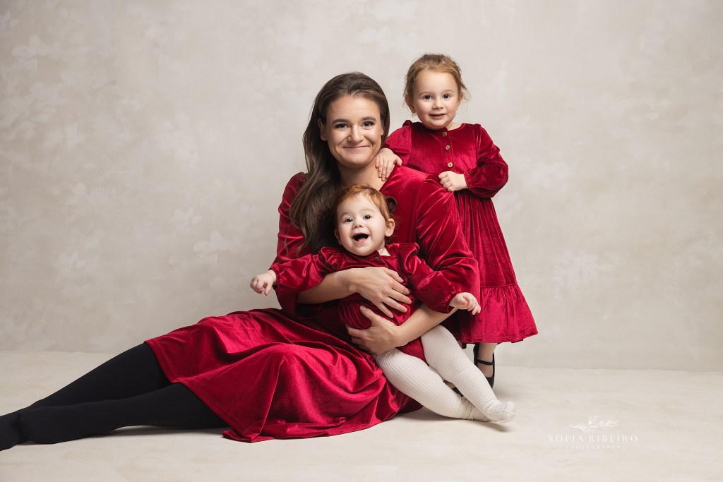 a wallington nj family photographer captures a joyful portrait of mom with her two daughters in matching outfits