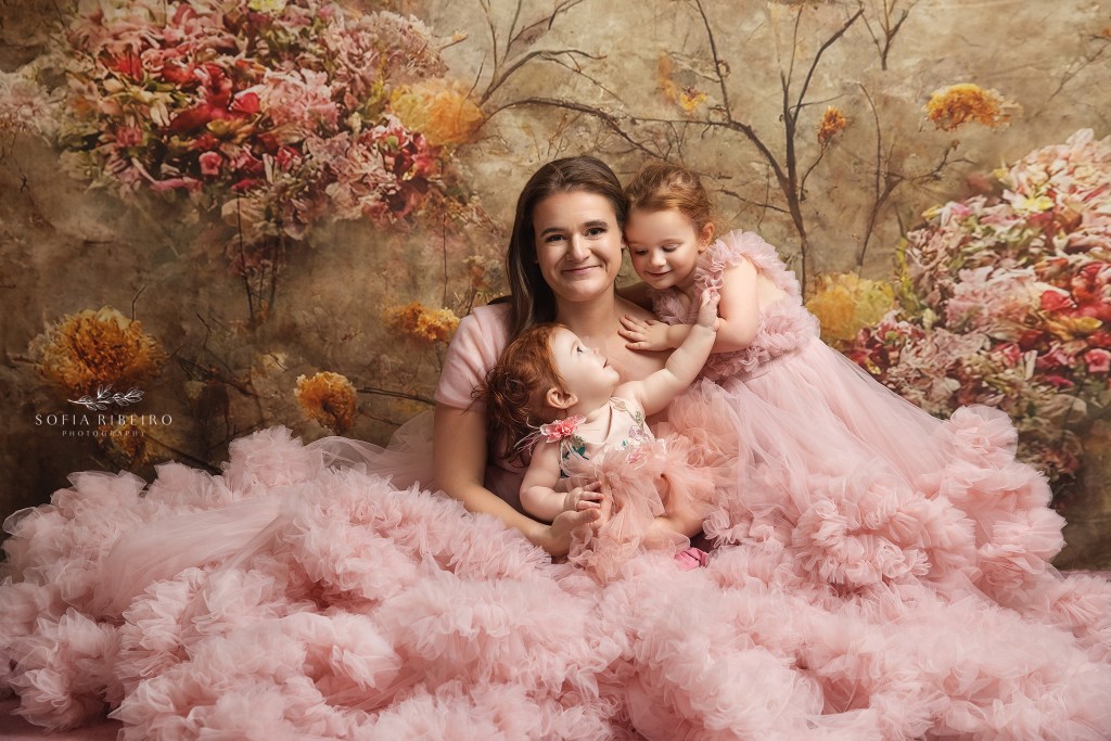 mom poses with daughters for a portrait session with wallington nj family photographer