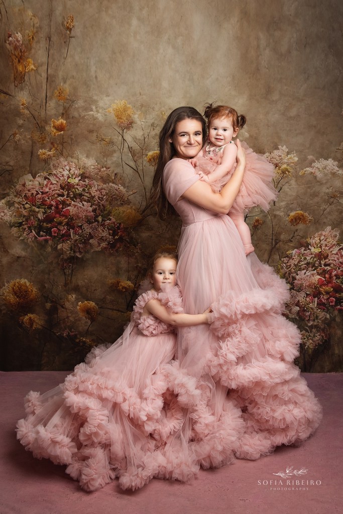 mom poses with daughters for a portrait session with wallington nj family photographer