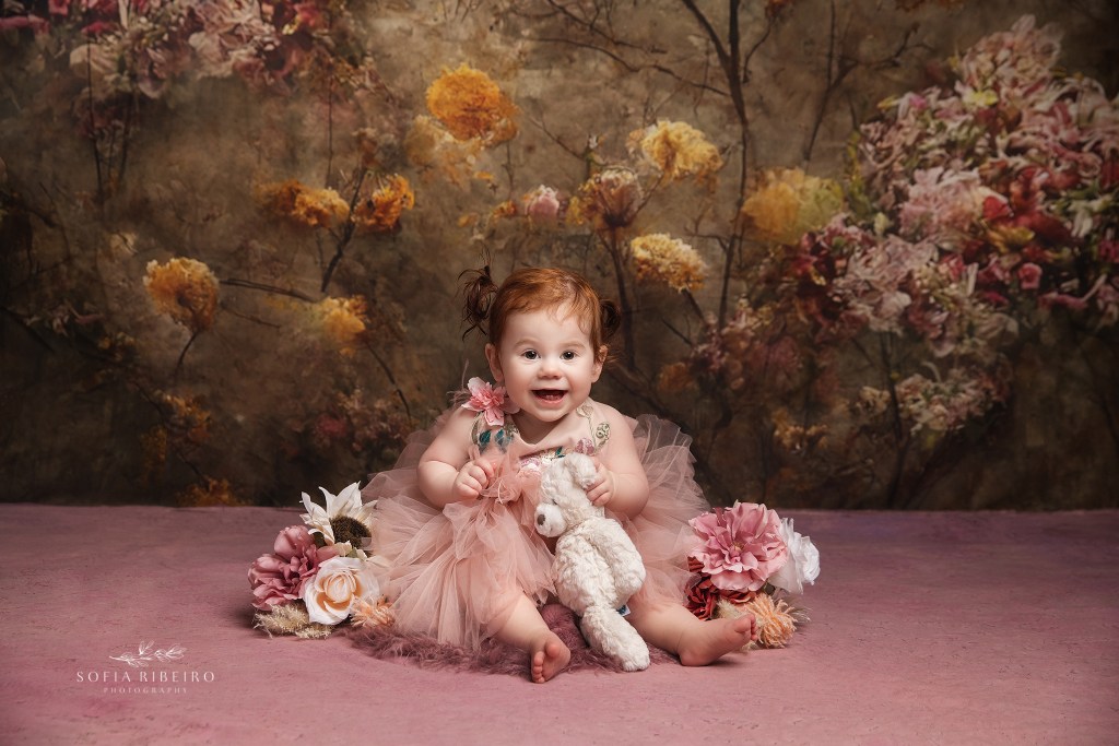 one year old girl smiles for a photo for familiy portraits with a wallington nj photographer
