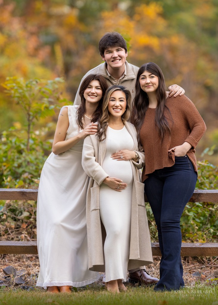 three siblings pose with an expectant mom outdoors in a beautiful fall scene for a warren nj family photographer