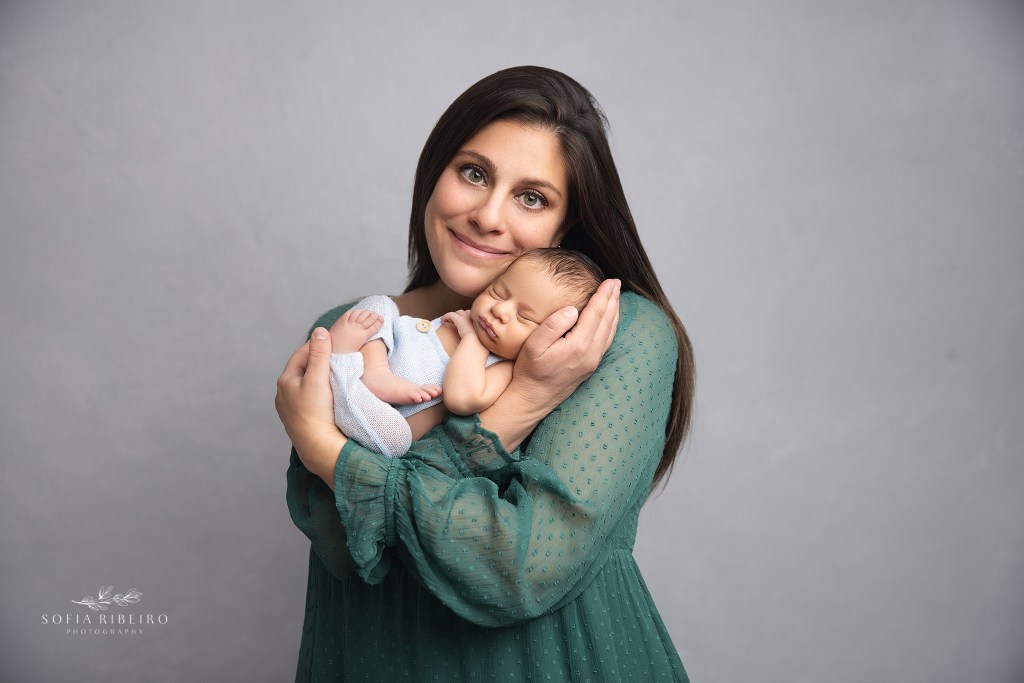 mom cuddles with her newborn baby boy for a newborn photographer in nj