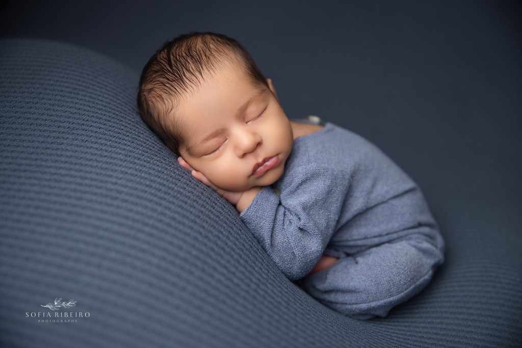 a dozing newborn baby boy sleeps soundly for newborn photos