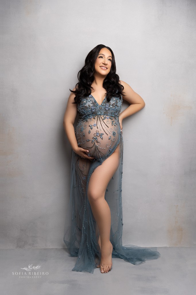 belleville nj maternity photographer captures a mom in a sheer beaded dress showcasing her baby bump