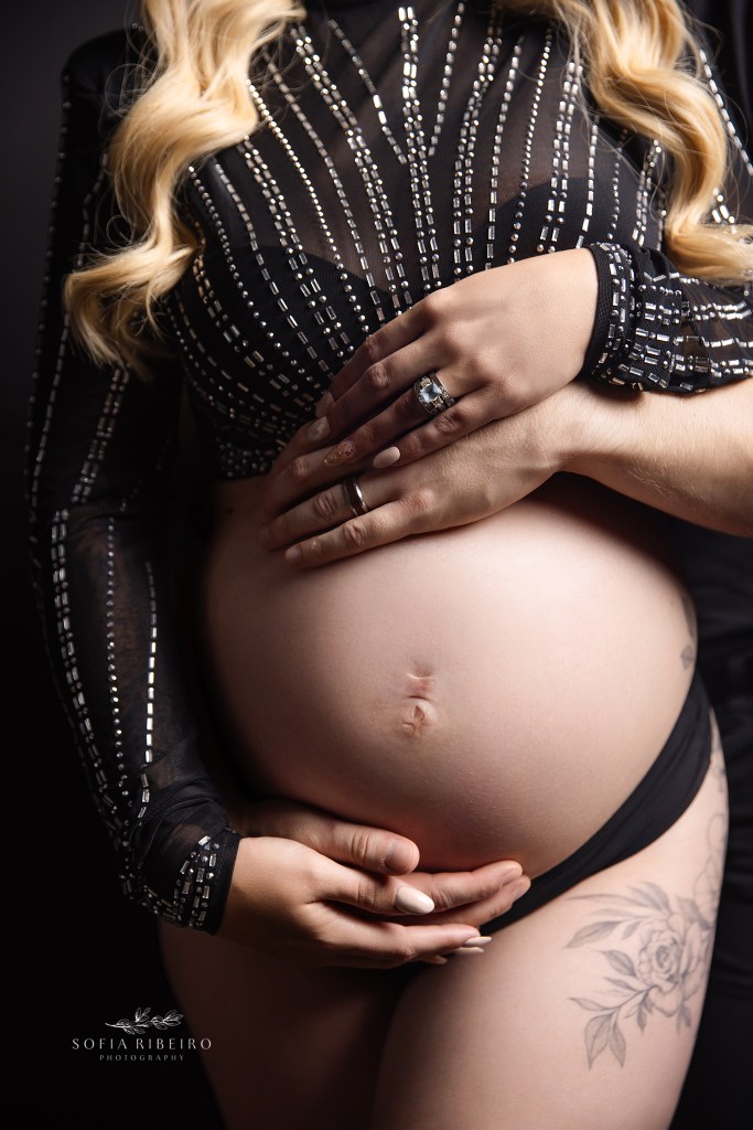 randolph nj maternity photographer showcases a closeup of a baby bump wrapped in black with parents hands