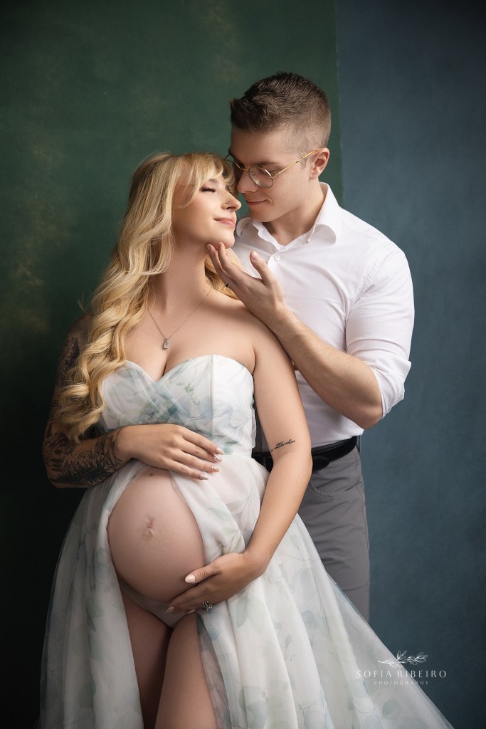 randolph nj maternity photographer poses a couple lovingly together in shades of white and green