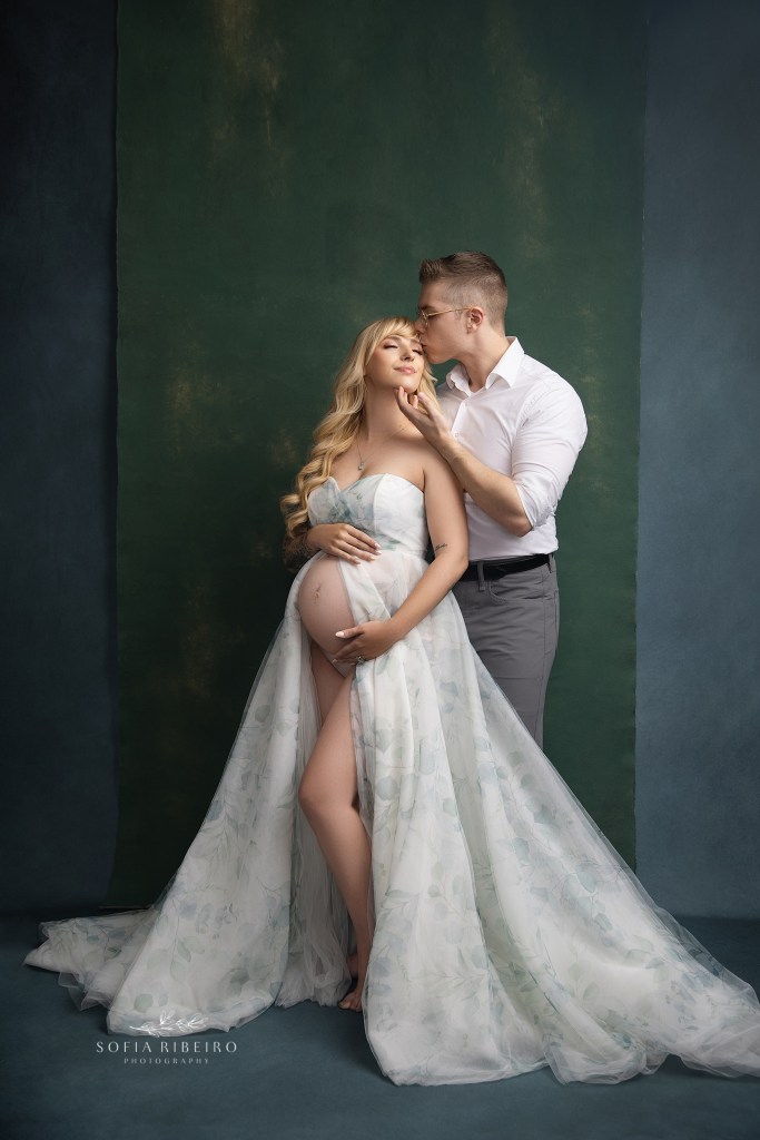 mom and dad pose lovingly together in a full body portrait for maternity photos