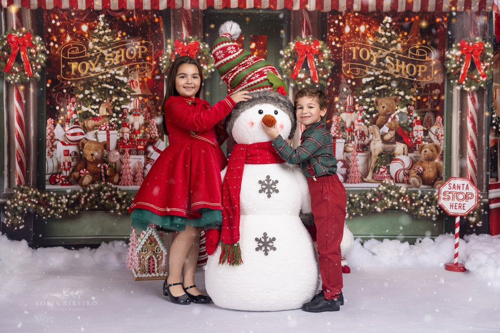 children play with a faux snowman for holiday photos in nj