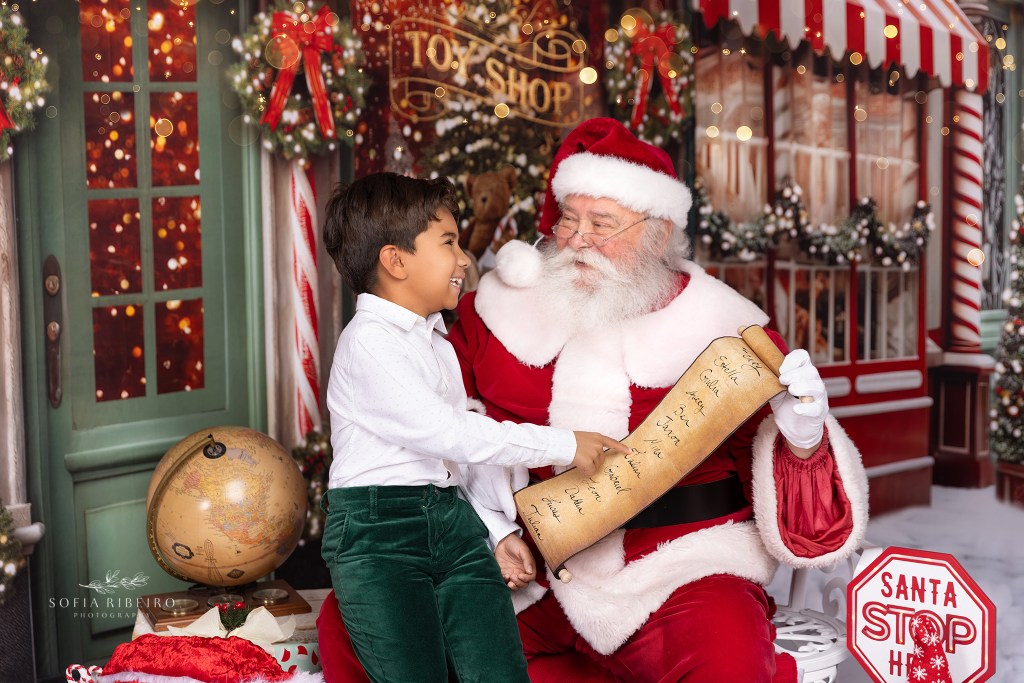 child finds his name on santa's list with an interactive experience with santa photos in nj