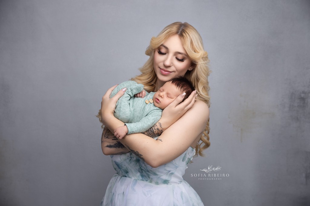 mom shares a cuddle with her newborn baby boy