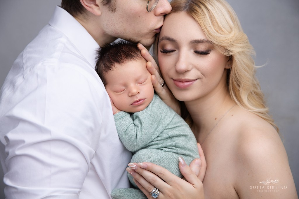 mom and dad sweetly snuggle their baby boy for a photo with a dover nj newborn photographer