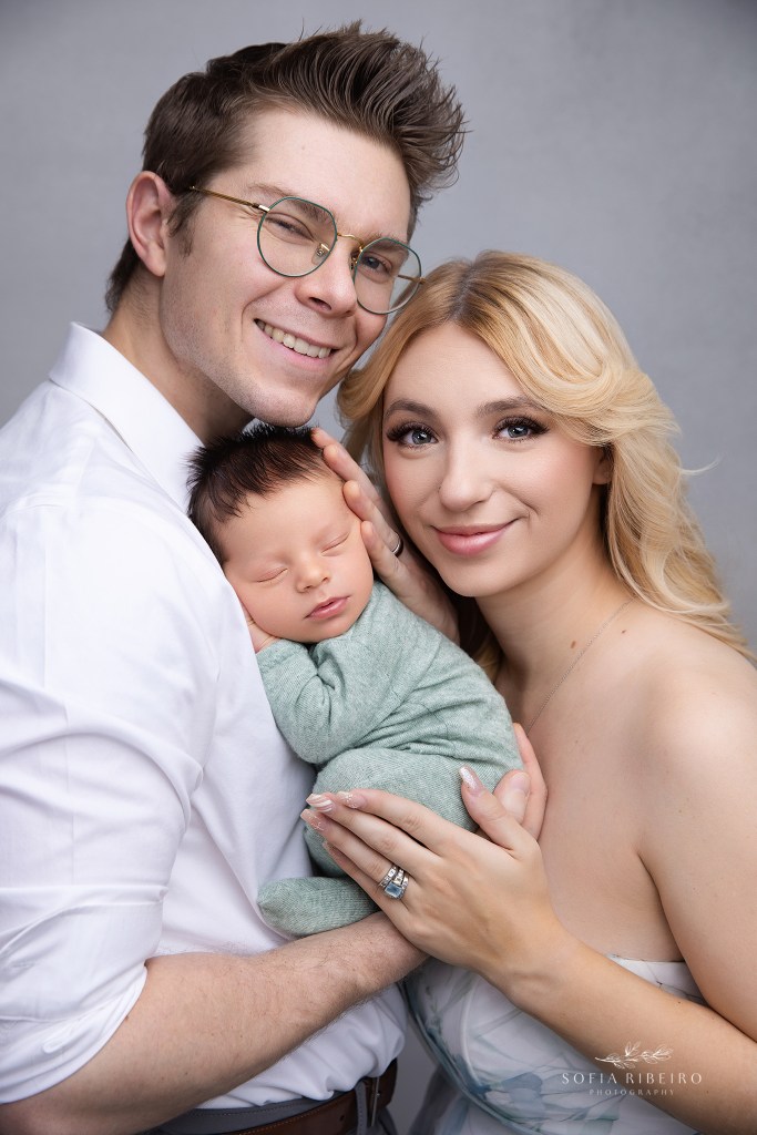 mom and dad sweetly snuggle their baby boy for a photo