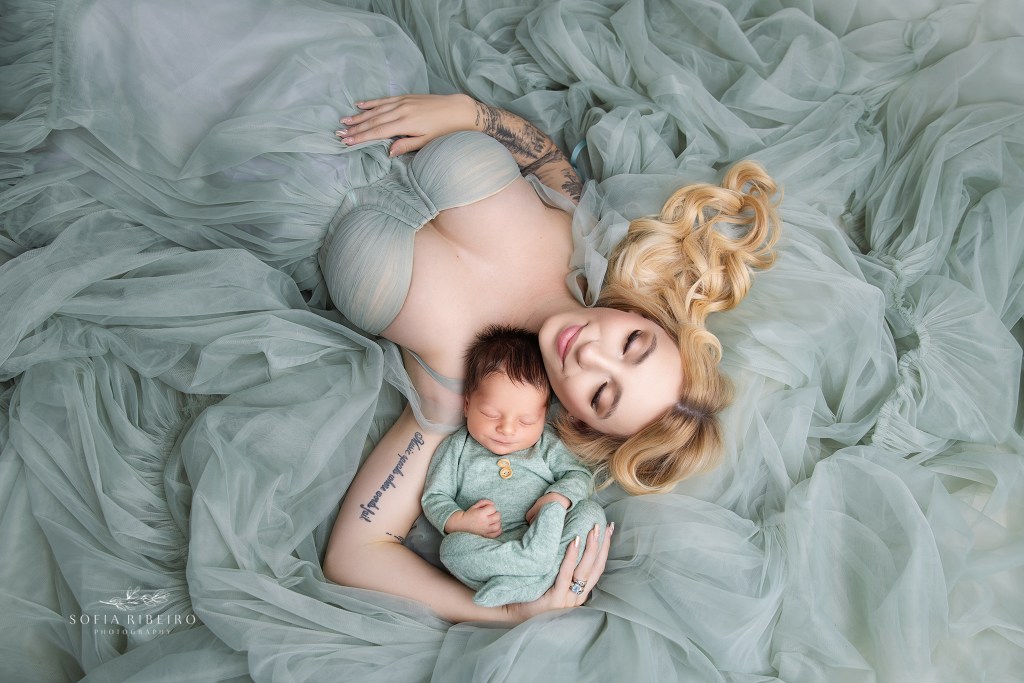 dover nj newborn photographer captures a sweet shot of mom snuggling baby in a sage green dress