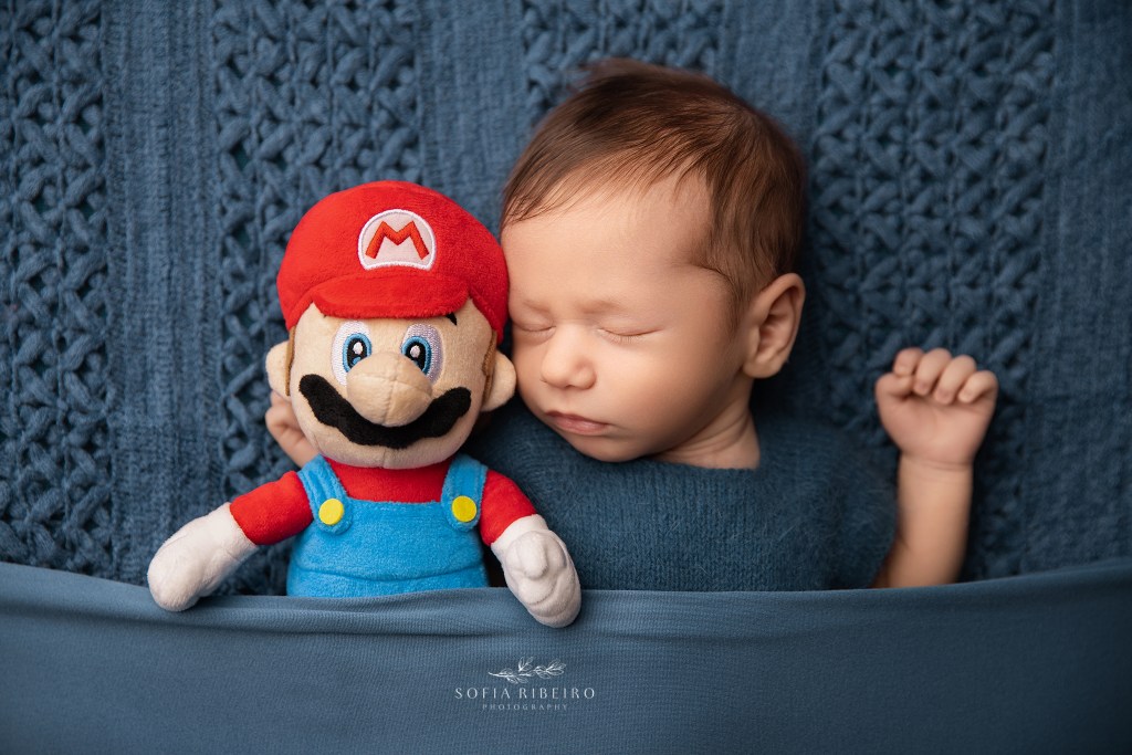 baby boy snuggles a special toy with meaning for their family