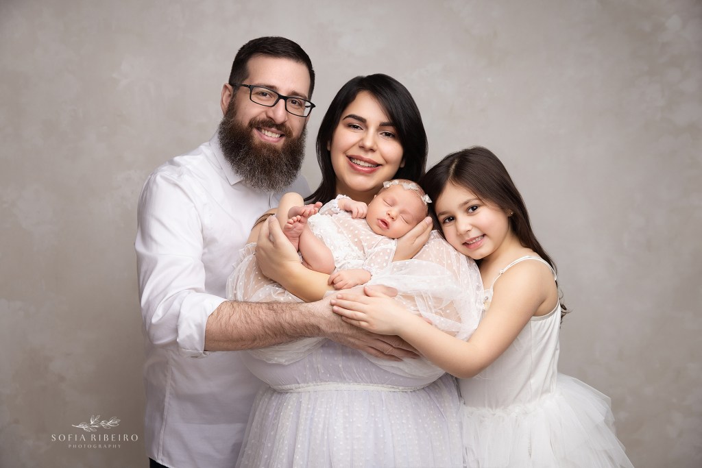 a sweet family portrait of 4 with their newest baby, beaming and proud for dunellen nj newborn photographer
