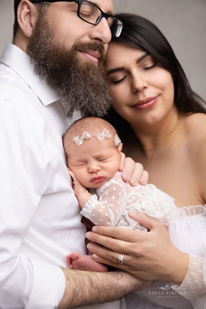 a closeup shows baby's tiny features in mom and dad's hands during a photo session in a dunellen nj newborn photographer's studio