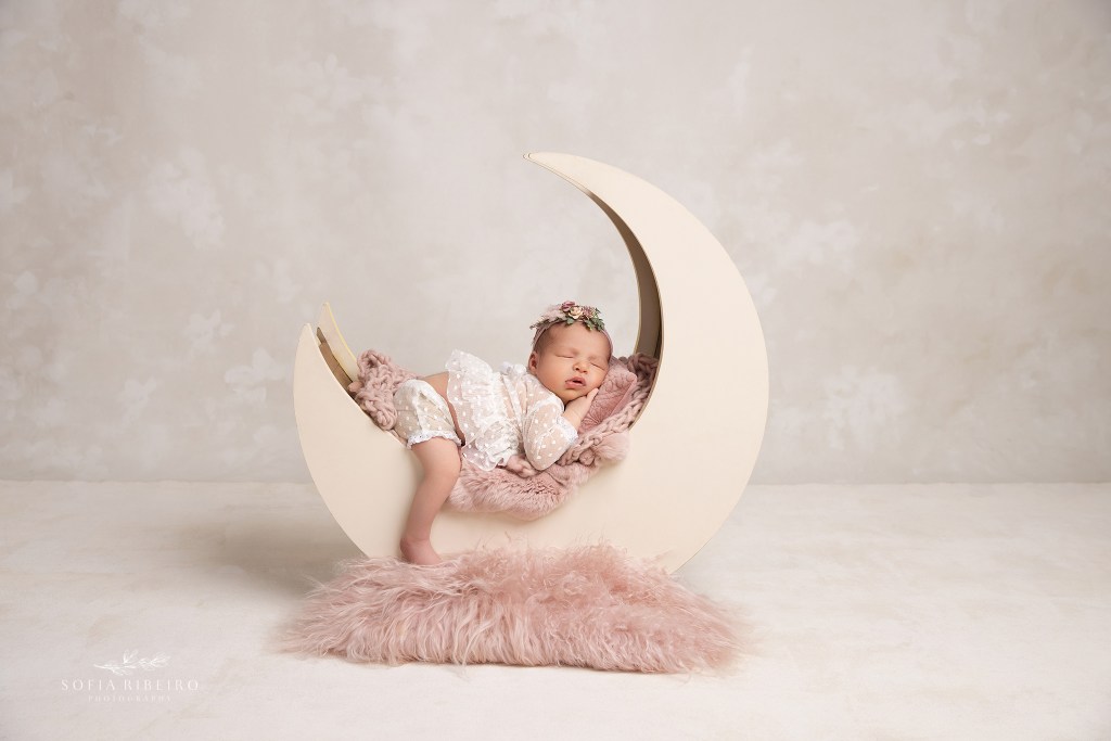 dunellen nj newborn photographer poses a newborn sweetly sleeping in a moon prop