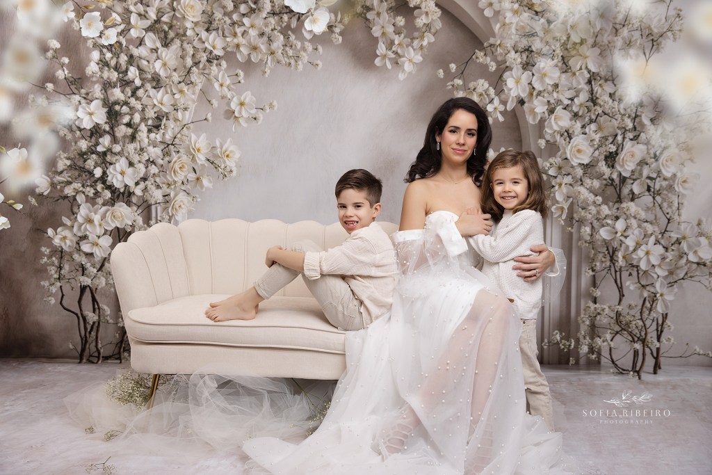 mom poses with her two boys in all creams and white for mommy and me portraits in nj