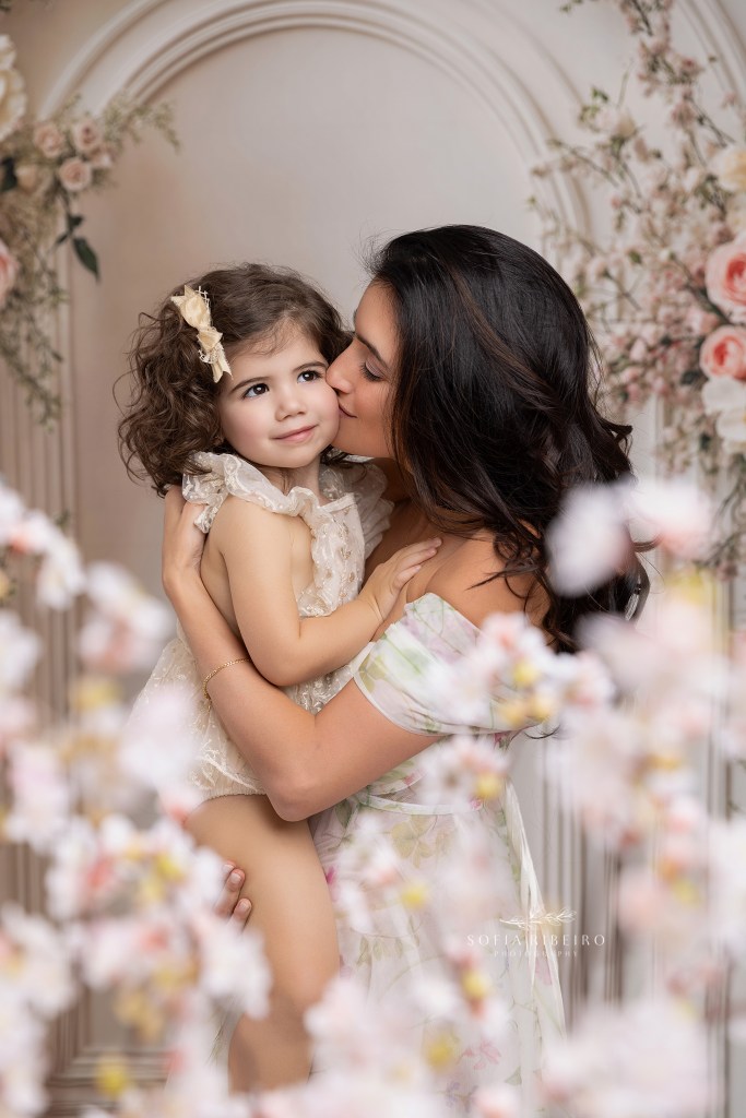 mom shares a kiss with her baby girl during portraits with nj family photographer