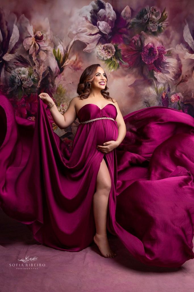 mom to be shines in a splendid magenta draped fabric for a maternity photo highlighting her bump by a whippany nj maternity photographer