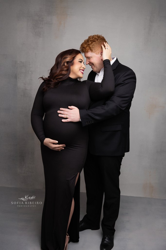 mom and dad share a tender moment while cradling the baby bump for a maternity photo in whippany nj