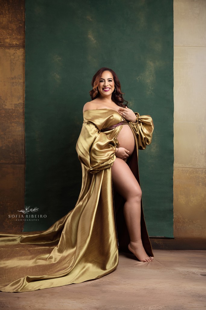 mom poses proudly exposing her baby bump for maternity portraits
