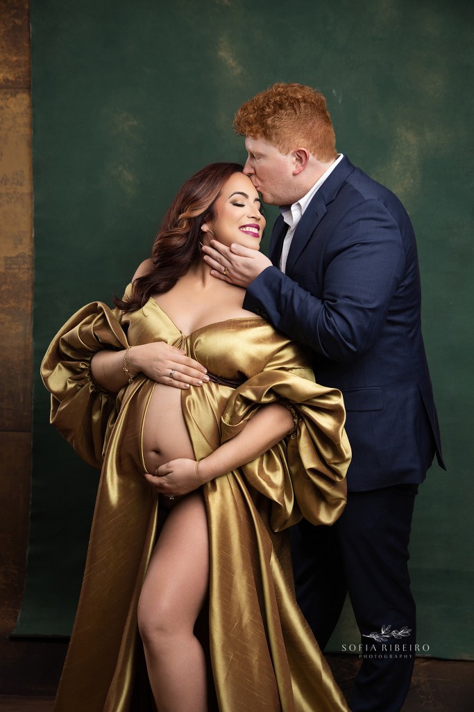 dad gives mom a gentle kiss on the forehead during a maternity session in whippany nj