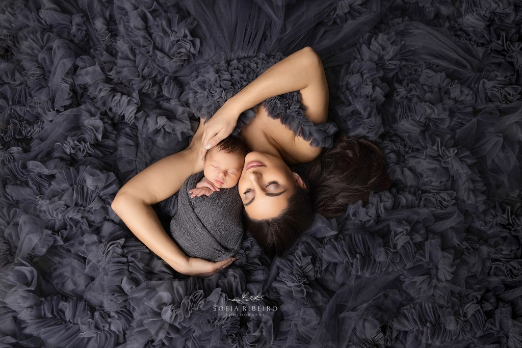 mom and baby are posed together in a bed of grey ruffles by berkeley heights nj newborn photographer