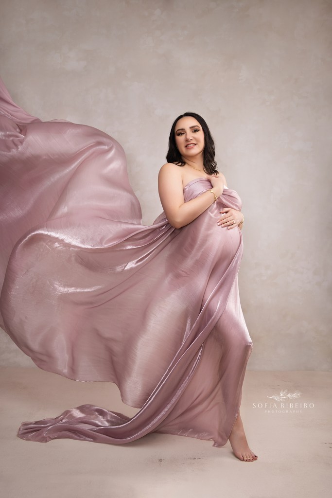 draped flowing fabric highlights mom's expectant baby bump during a maternity session in hudson valley ny