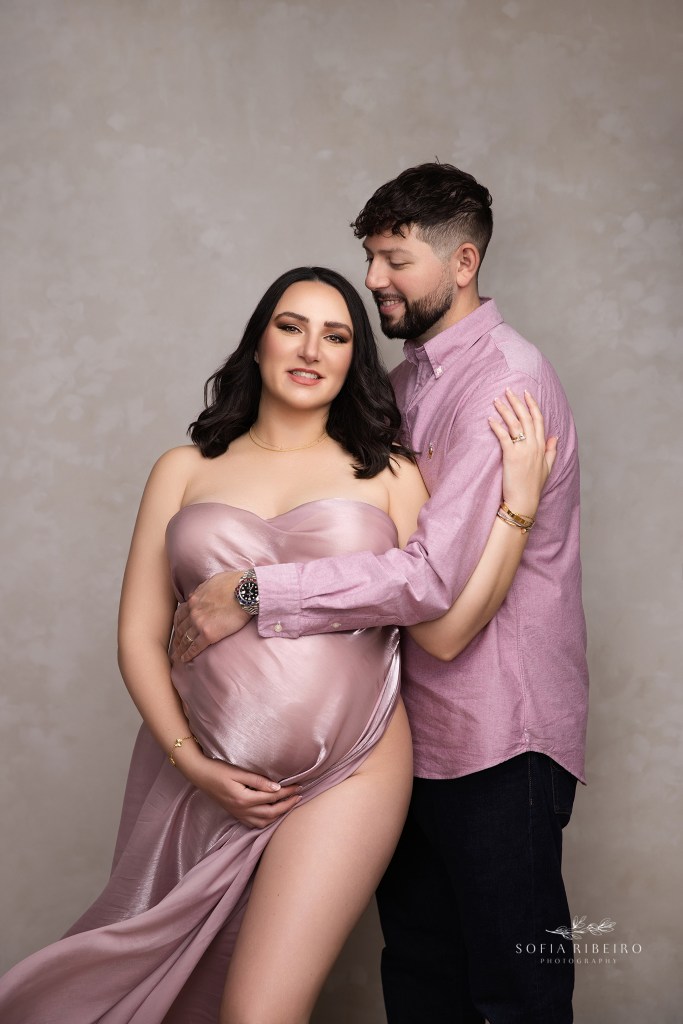 mom and dad share a sweet moment in matching pink outfits