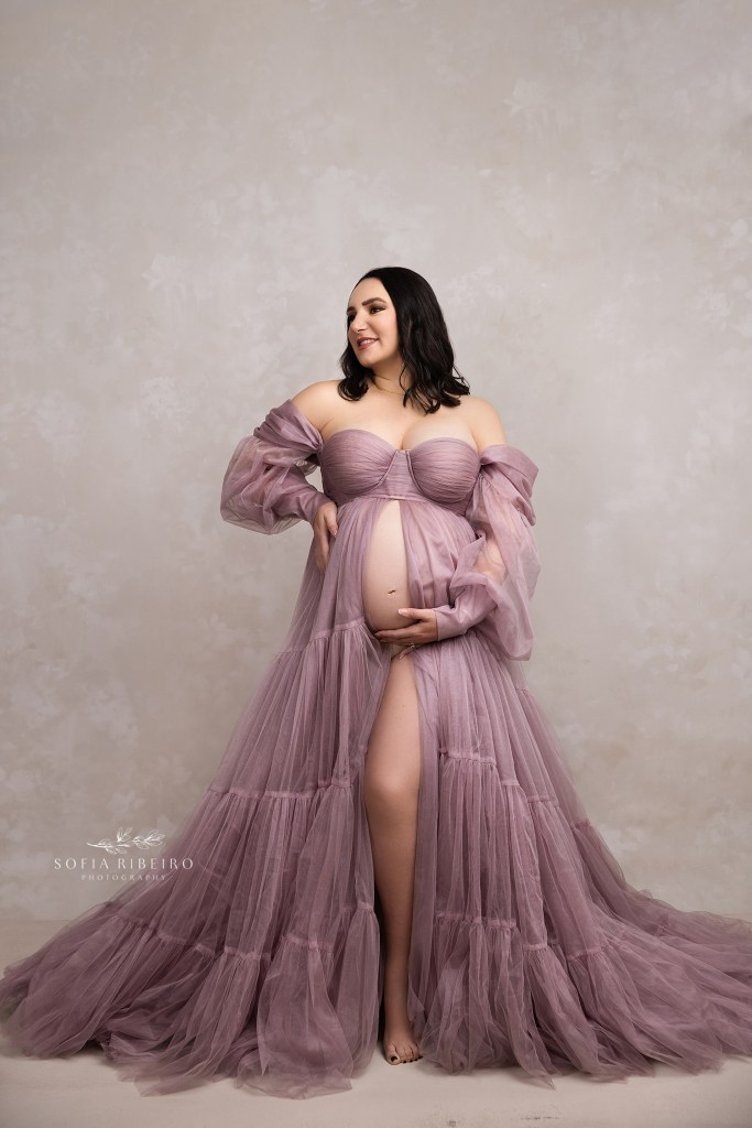 mom to be poses in a lavender tulle gown