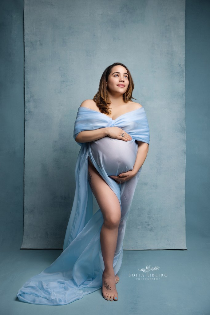 lodi nj maternity photographer poses mom in a draped blue flowing fabric
