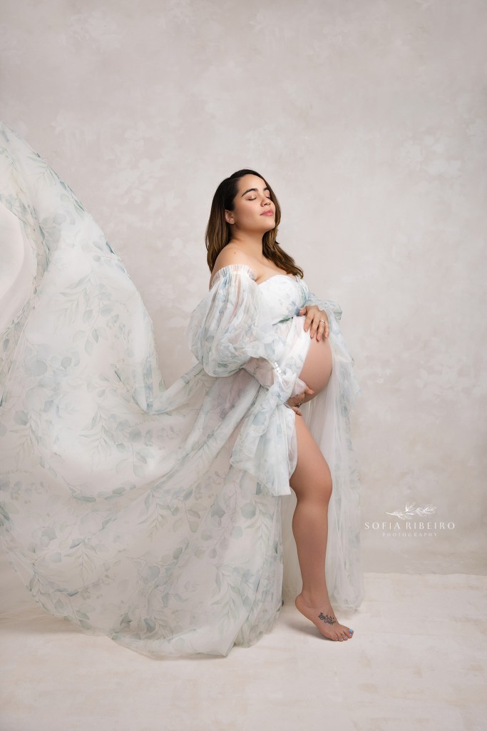 a flowing gown in soft shades of eucalyptus brings the focus to moms belly