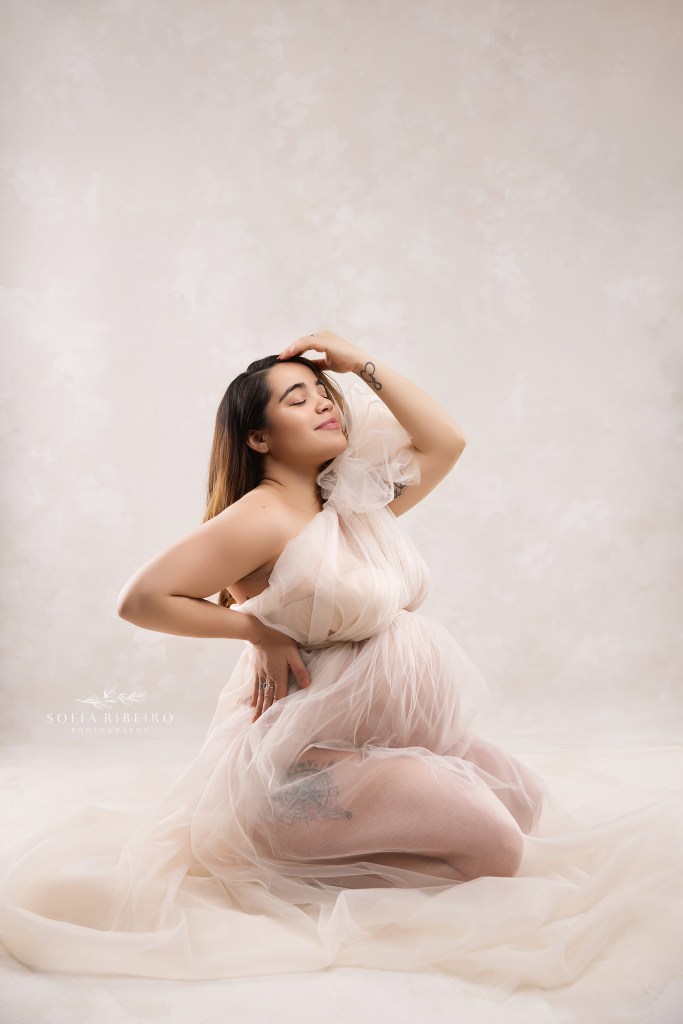 lodi nj maternity photo studio captures mom in an elegant kneeling pose
