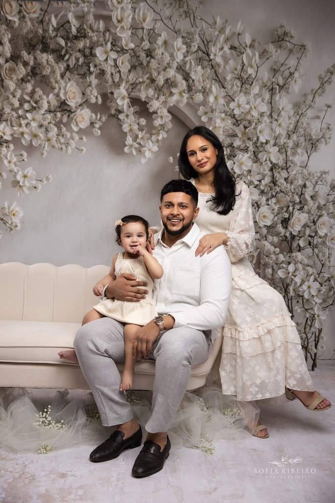 staten island ny family photographer captures a beautiful portrait of a family together against a cream floral backdrop