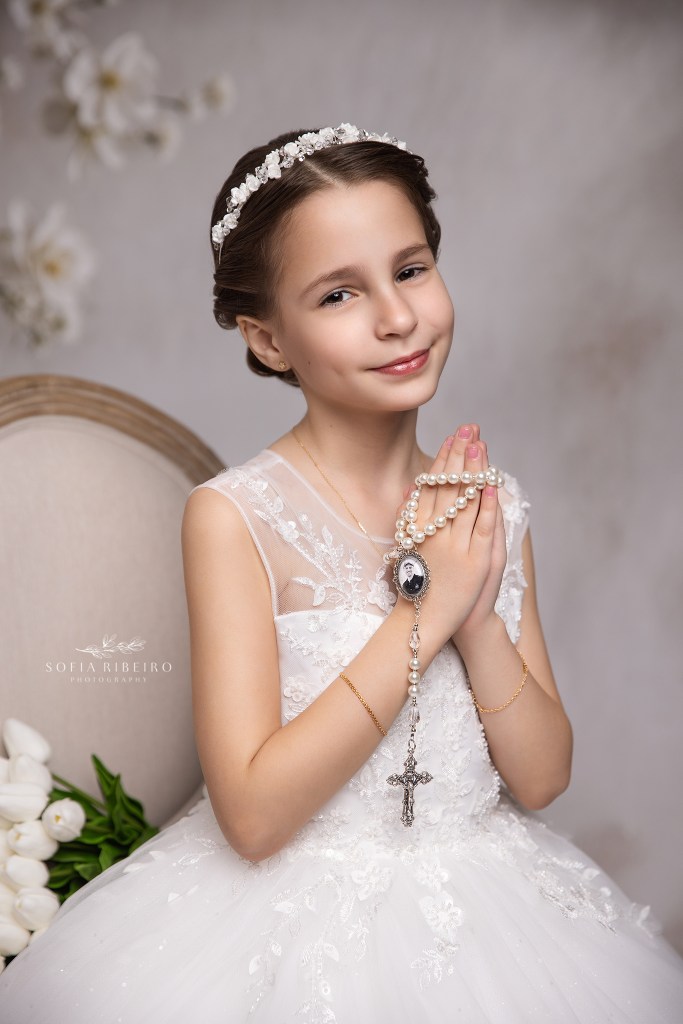 westfield nj communion photographer captures a gorgeous portrait of a little girl with sentimental details seated in a chair
