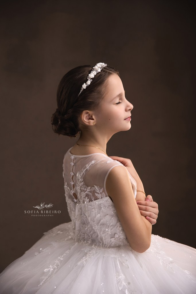 a soft side profile portrait of a little girl in her communion dress showing hair and back details in a westfield nj photography studio