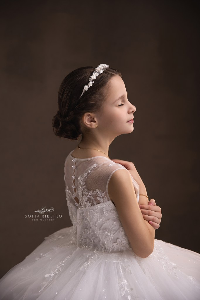 a soft side profile portrait of a little girl in her communion dress showing hair and back details in a westfield nj photography studio