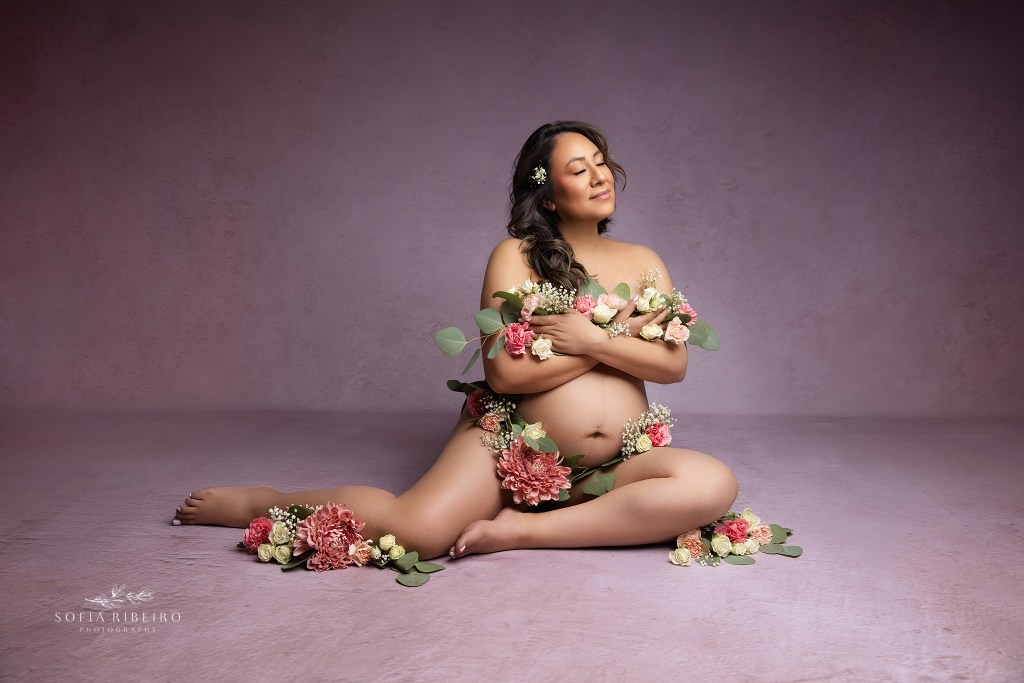 an ethereal pose by englewood nj maternity photographer places mom in the midst of flowers