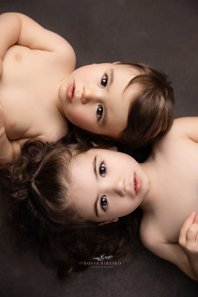 monmouth county nj baby photographer captures an intimate portrait of two siblings in a close-up showing their sweet faces.