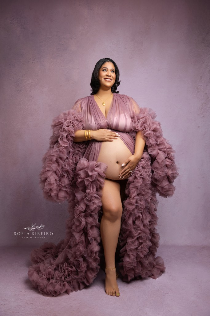 mom poses for portraits with an oakland nj maternity photographer