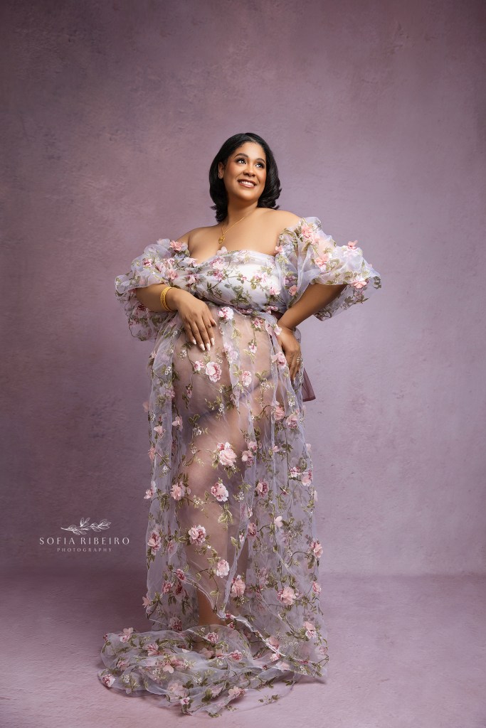 mom showcases her pregnant belly in a sheer gown for portraits with an oakland nj maternity photographer