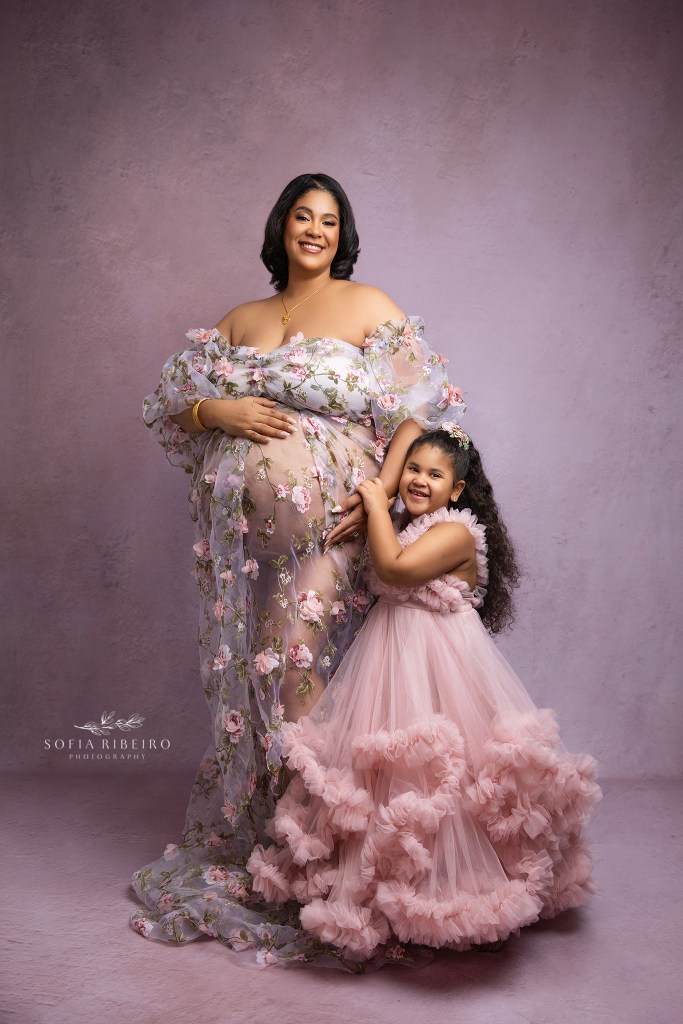 mom and big sister pose, hugging the belly for a sweet maternity portrait