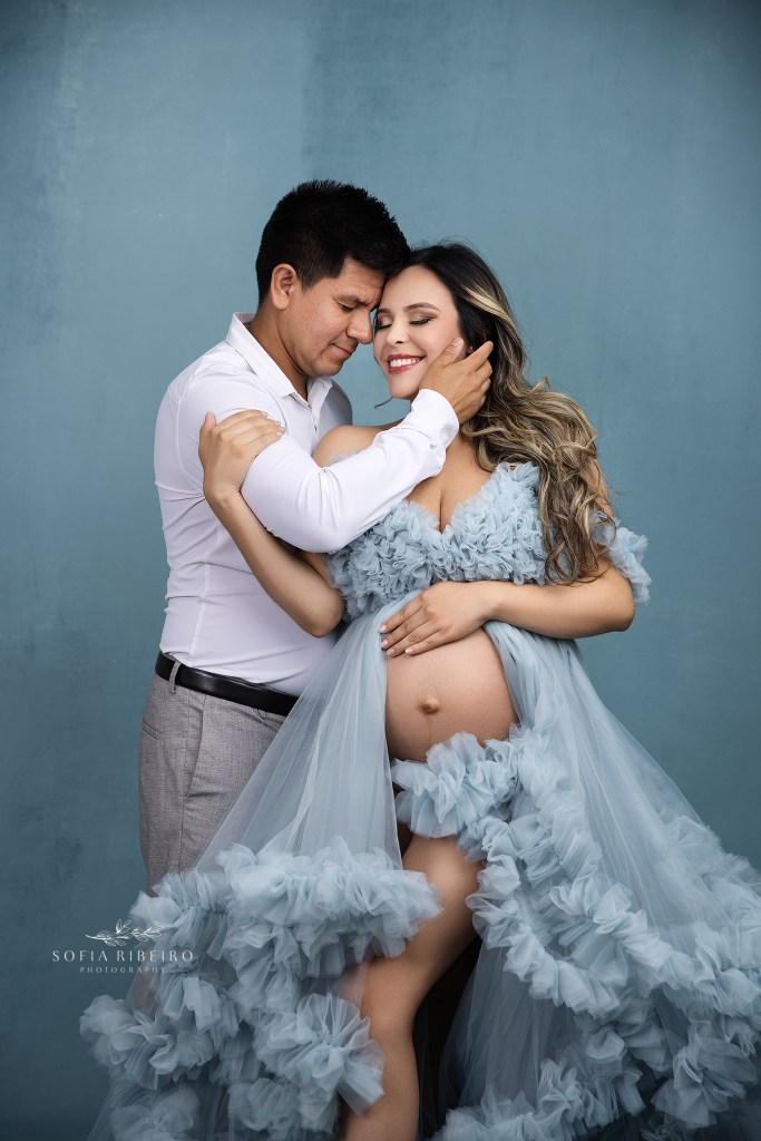 mom and dad share a sweet moment for a maternity portrait session in glen ridge nj