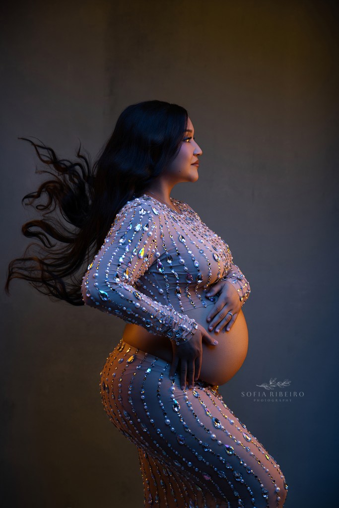 nutley nj maternity photographer uses gel lighting to highlight mom's growing curves