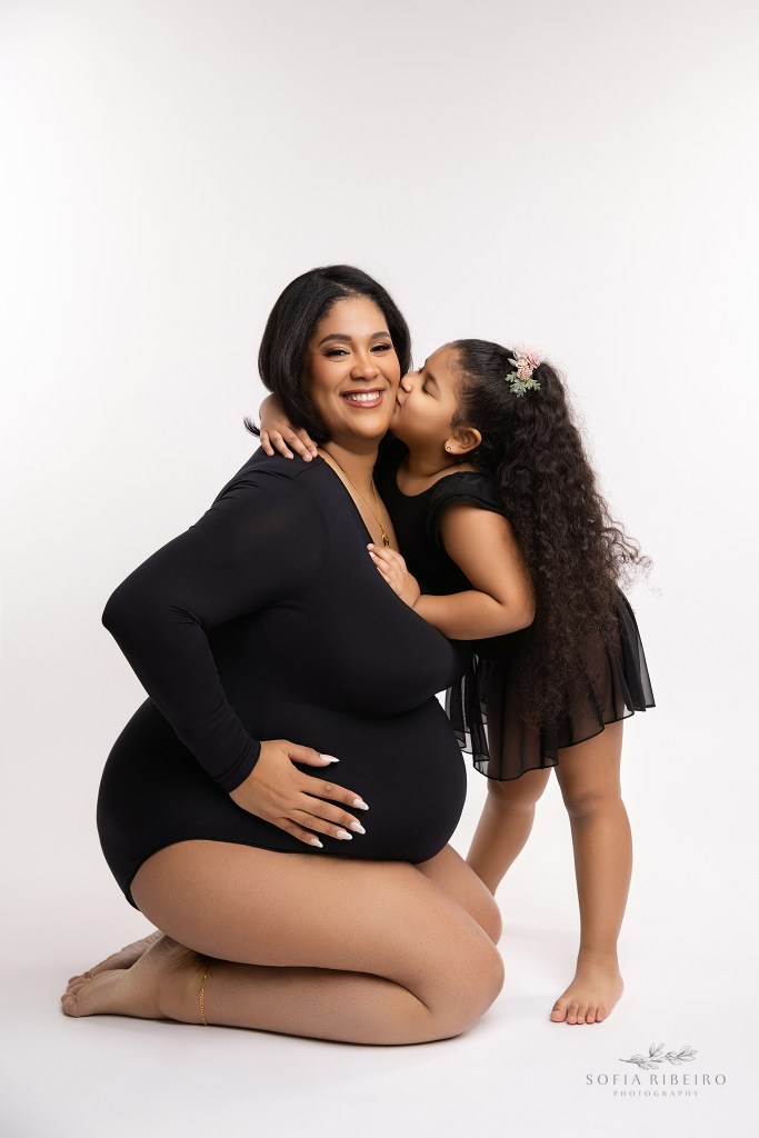 mom and daughter pose in matching black bodysuits for maternity photos in oakland nj