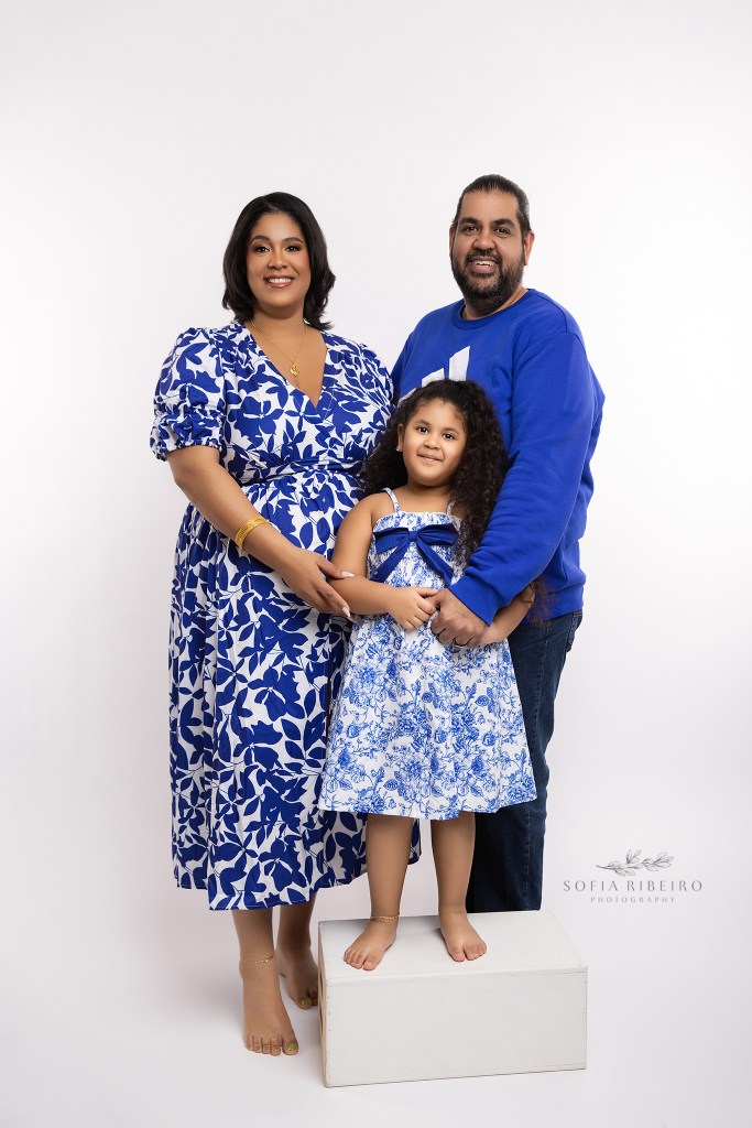 an nj portrait photographer poses a family in corresponding blue looks