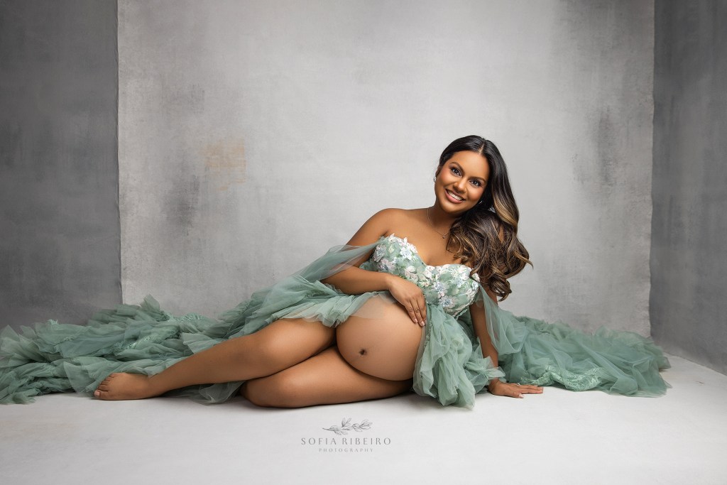 franklin lakes nj maternity photographer poses mom in a green tulle gown against a grey backdrop