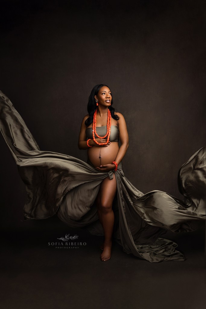 franklin nj maternity photographer captures a radiant mom to be in olive green satin fabric and orange coral beads from nigeria