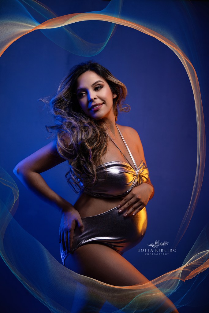 glen ridge maternity photographer plays with gel lighting effects to highlight mom's growing bump